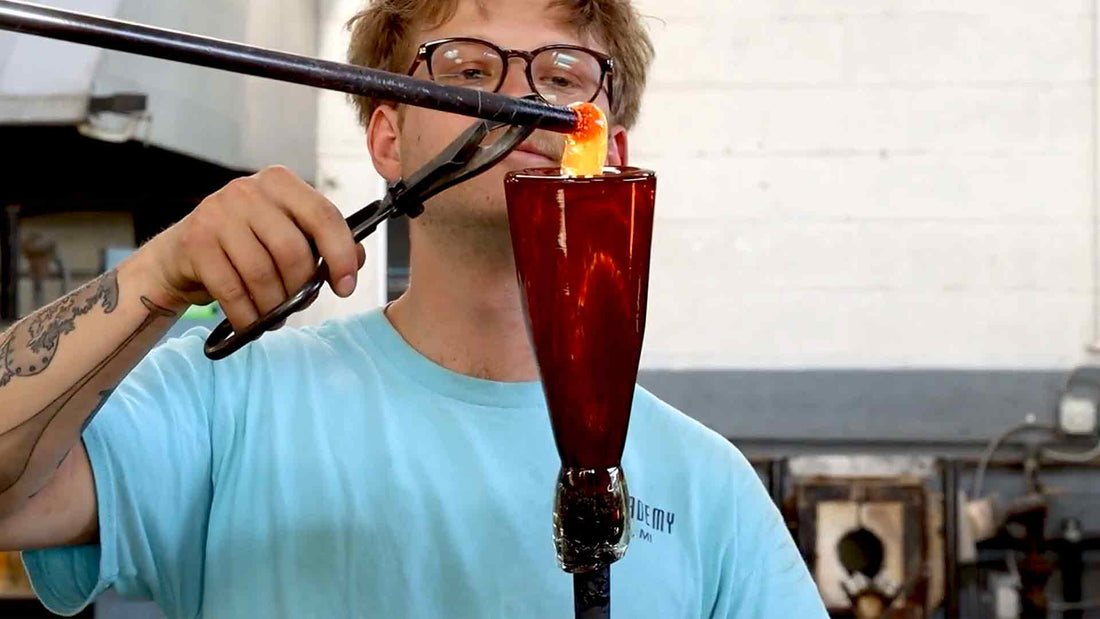 Artist Jacob Nordin is Glass Blowing a goblet at the Glass Academy